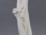 white marble statue of a woman holding a basket of flowers