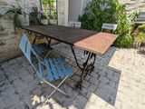 a table and two chairs on a brick patio