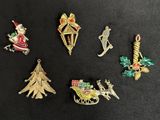 six different christmas ornaments on a black surface