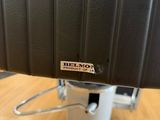 a close up of a black chair with a metal base