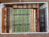 a box full of old books sitting on the floor