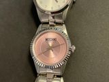 two watches that are sitting side by side on a table