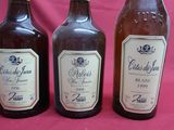 three bottles of beer are lined up on a pink background