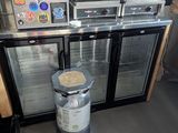 a picture of a commercial kitchen with two refrigerators and a coffee maker