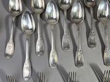 a lot of silver spoons and forks on the table