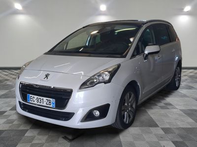 the small silver car is parked in a large room