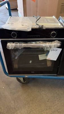 a blue cart with a black oven on top of it