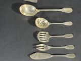 a lot of silver spoons and spoon spoons on a table