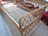 a bed with a metal frame and a mattress on the floor