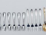 a lot of spoons and forks on the table