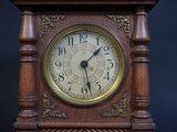 a wooden clock that is sitting on a table