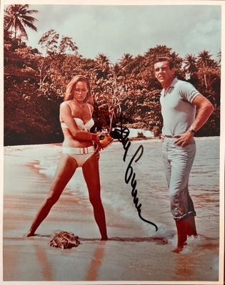 an old photo of a man and a woman on the beach