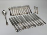 a lot of silverware on a table with spoons and forks