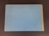 a blue book sitting on top of a brown table