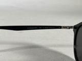a close up of a pair of black sunglasses on a white surface