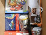 a cardboard box filled with toys and other items