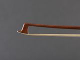 a close up of a violin bow with a wooden handle