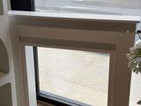 a cat sitting on a window sill in front of a window