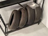 a shelf with tires on it in a garage