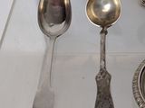 several spoons and spoon spoons are sitting on a clear tray