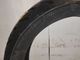 a close up of a tire on a white surface