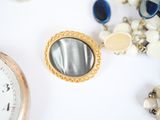 a close up of a pocket watch and a bunch of jewelry