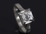 a close up of a diamond ring on a black surface