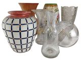 many different vases and glasses on the table
