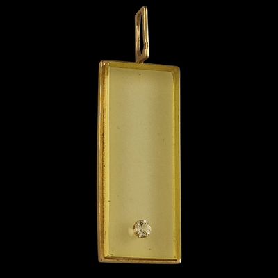 an image of a gold pendant with a diamond in the center