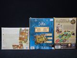 three board games that are on a black table