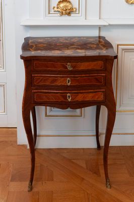 a small wooden table with a marble top on a hard wood floor