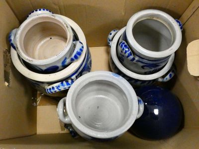 three blue and white vases in a cardboard box