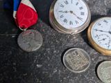 a few coins and a pocket watch on the floor