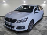 the white car is parked on a checkered floor in the garage