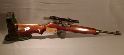 a wooden rifle with a gun on it on a white surface