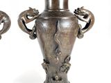 two vases with handles that have animals on them