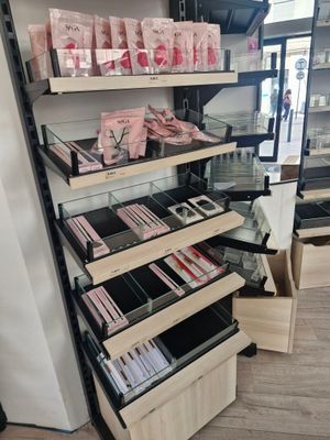 a lot of makeup products on the shelves in the store