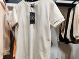 many shirts hanging on a rack in a clothing store