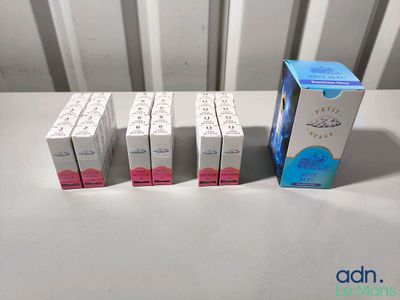 four boxes of toothpaste sitting next to each other on a table