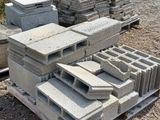 a pile of concrete blocks on the ground in a field