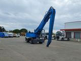 a blue crane that is sitting in a parking lot
