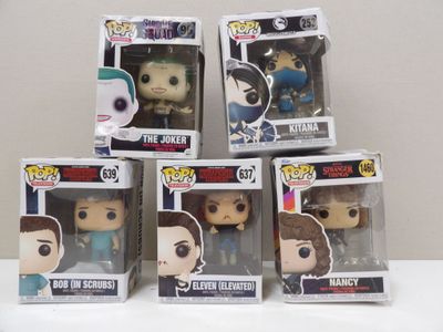 five funko pop vinyl figures in boxes on a white surface