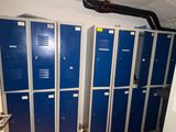 several blue lockers are lined up in a row in a room