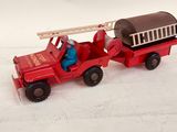 a toy fire truck with a barrel on the back of it