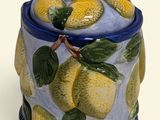 a blue and yellow jar with lemons on it