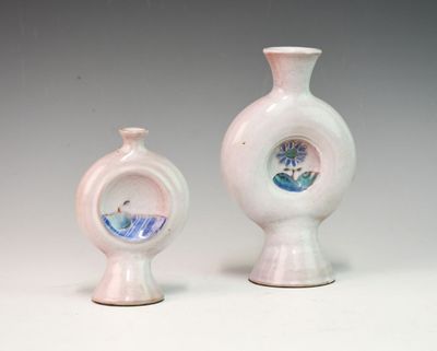 two vases sitting next to each other on a table