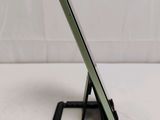 a close up of a cell phone on a stand on a table