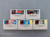 six nintendo game cartridges stacked on top of each other on a table