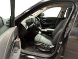 the interior of a car with the door open and the driver ' s seat up