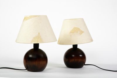 une paire de lampes de table en bois surmontées d'abat-jours